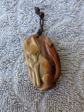 Carved stone Fox pendant with leather bail Carmel colors
